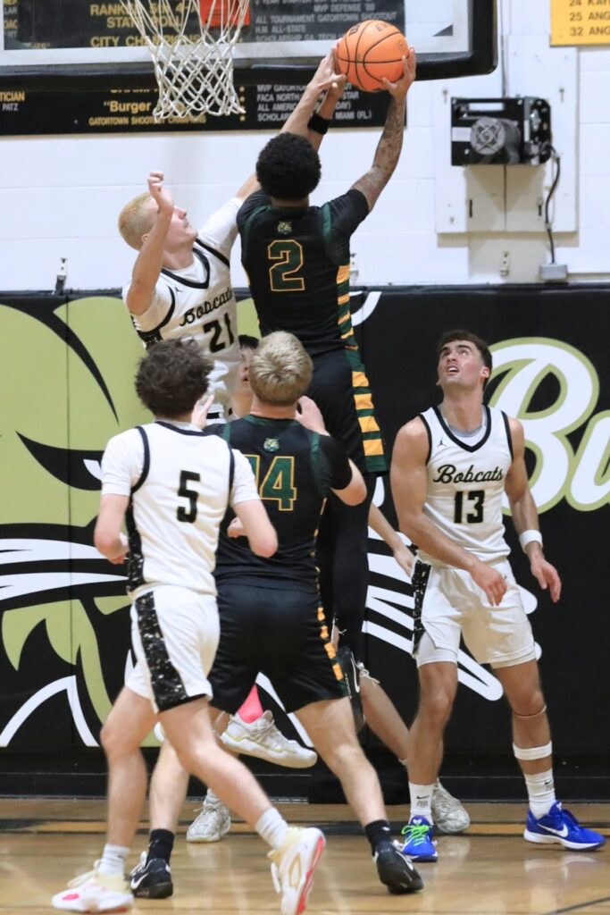 Buchholz's Gabe Williams (21) contests a shot against Forest (Ocala) in the Class 6A-Region 1 semifinal. . Photo by Seth Johnson