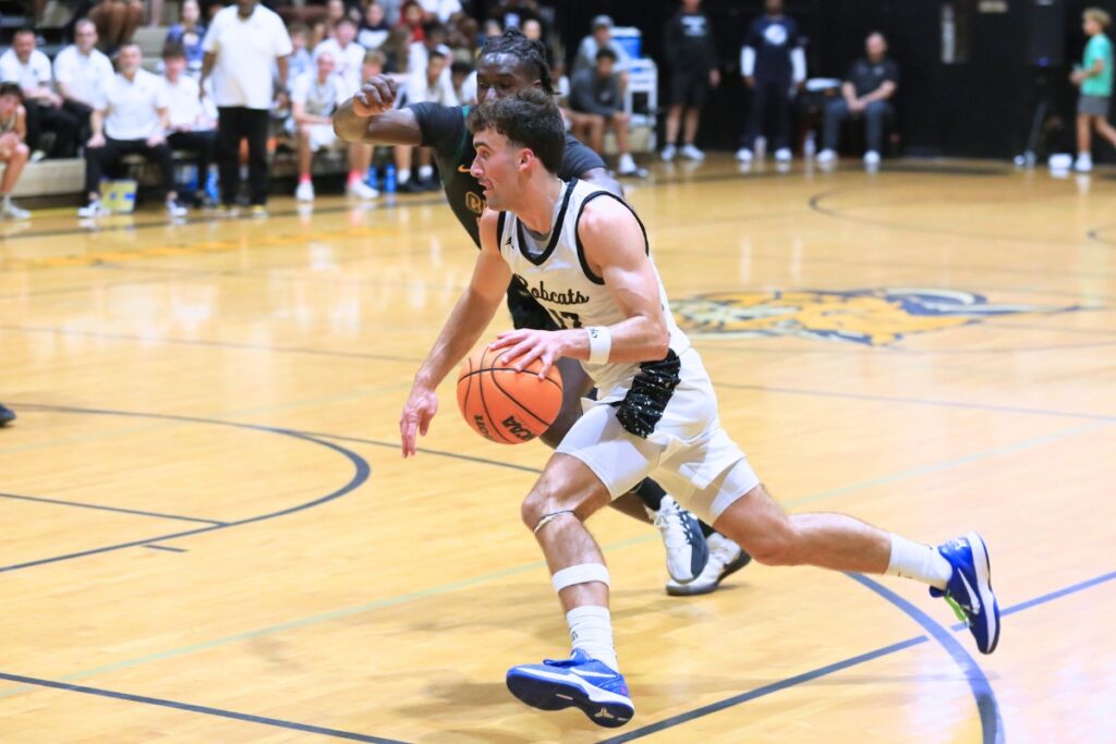 Buchholz's Jameson McTureous (13) slashes to the basket against Forest (Ocala) in the Class 6A-Region 1 semifinal. Photo by Seth Johnson
