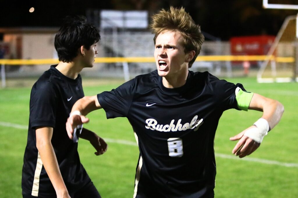 Buchholz's Timmy Ortiz (8) pumps up the crowd after tying the score 1-1 on a sideline throw-in against South Lake (Groveland) in the Class 6A-Region 1 Semifinals. Photo by C.J. Gish