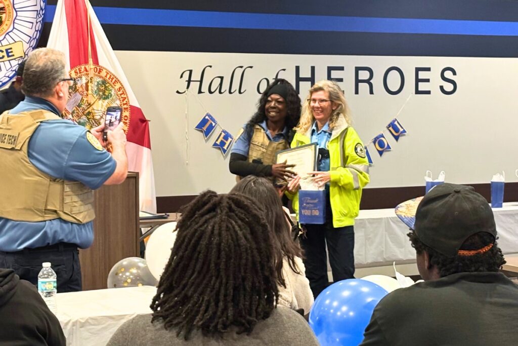 GPD School Crossing Guard Coordinator Pamela Miles presents a certificate to Mary Colon, a crossing guard at Lincoln Middle School. Photo by Kirsten Rabin