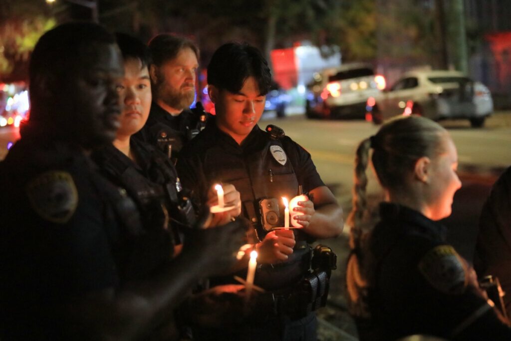 GPD officers gather during a candlelight vigil for Officer Scott Baird. Photo by Seth Johnson (1)