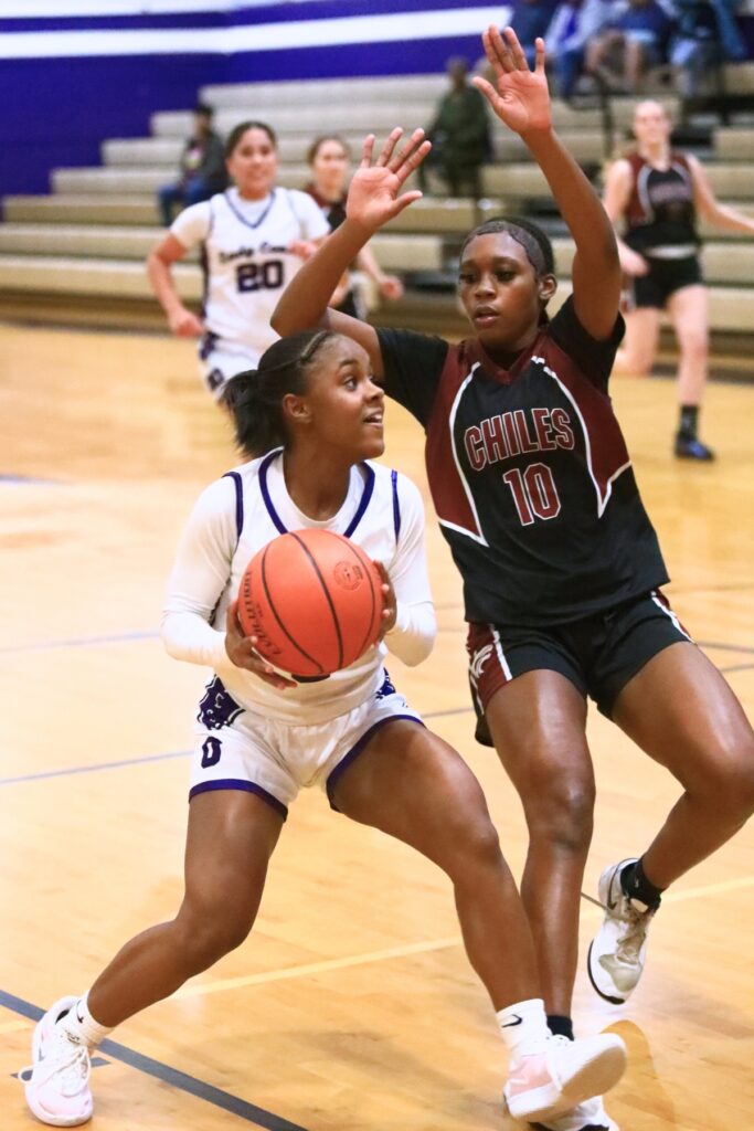Gainesville's Mateja Allen (0) drives to the basket against Chiles (Tallahassee) in the Class 5A-District 2 Semifinals. Photo by C.J. Gish