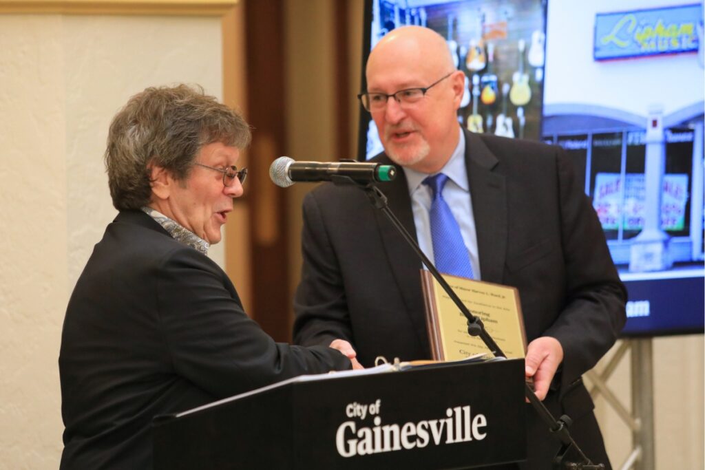 Greg McMillan receives Buster Lipham's award in his place. Photo by Seth Johnson