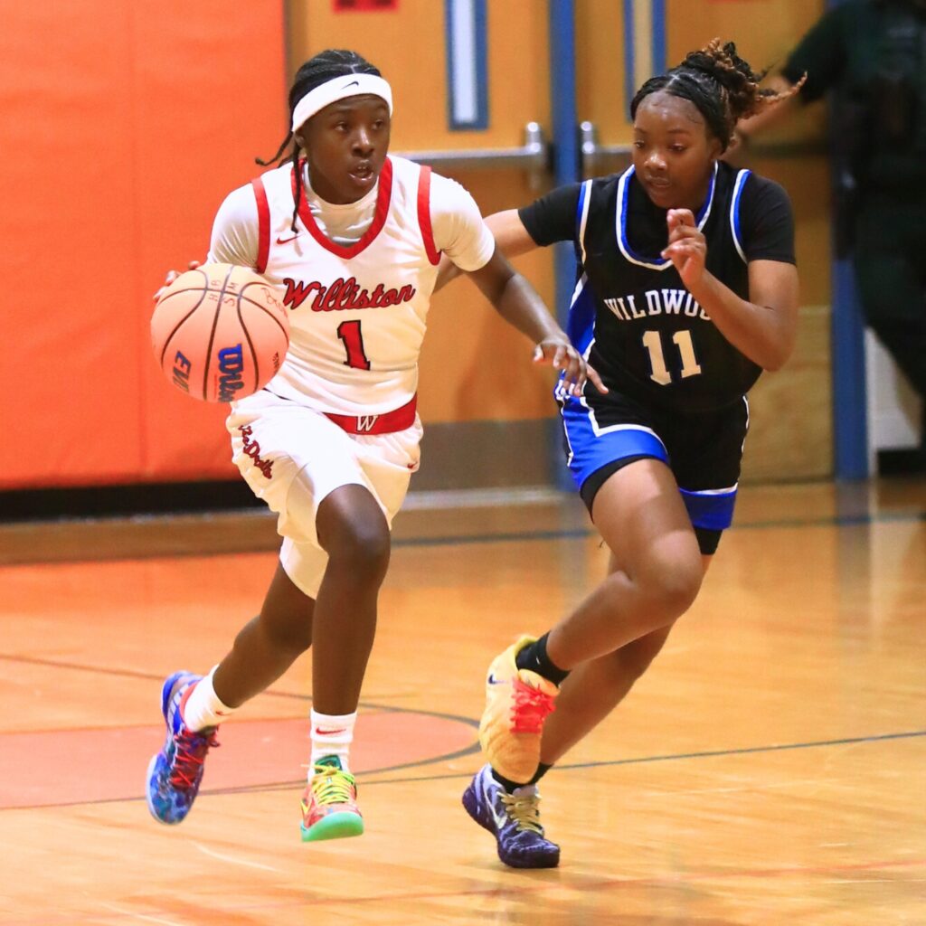 Kierce Solomon (1) pushes the ball downcourt against Wildwood in the Rural Class District 7 championship game. Photo by C.J. Gish