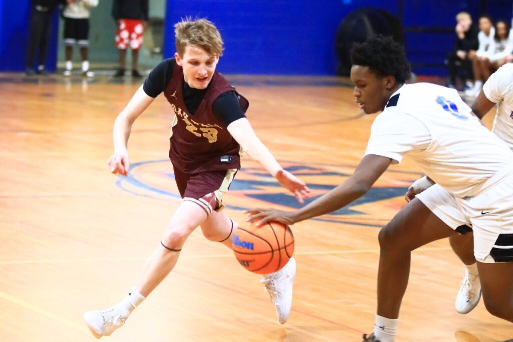 Oak Hall's Max Whitmer (23) and P.K. Yogne's Justin Speer (0) go after a loose ball in the Class 2A-District 2 Semifinals. Photo by C.J. Gish