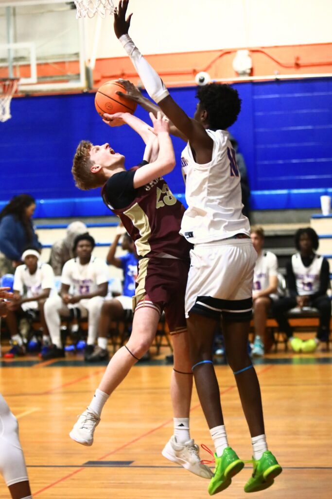 Oak Hall's Max Whitmer (23) has his shot blocked by P.K. Yonge's Eugene Hall (10) in the Class 2A-District 2 Semifinals. Photo by C.J. Gish