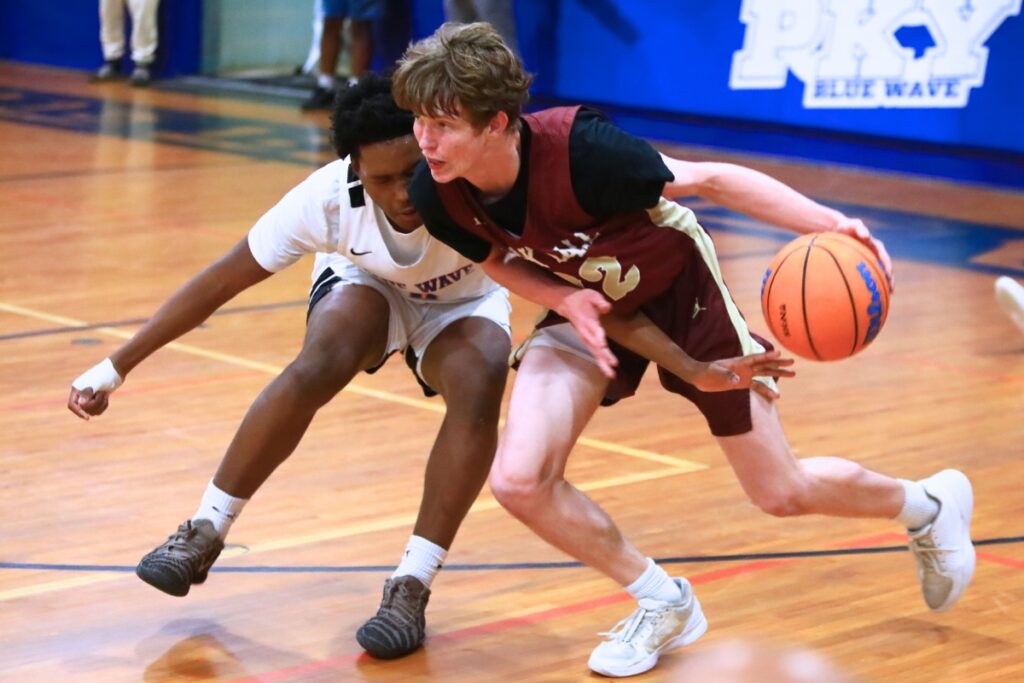 P.K. Yonge's Justin Speer (0) tries to steal the ball from Oak Hall's Elijah Medved (32) in the Class 2A-District 2 Semifinals. Photo by C.J. Gish