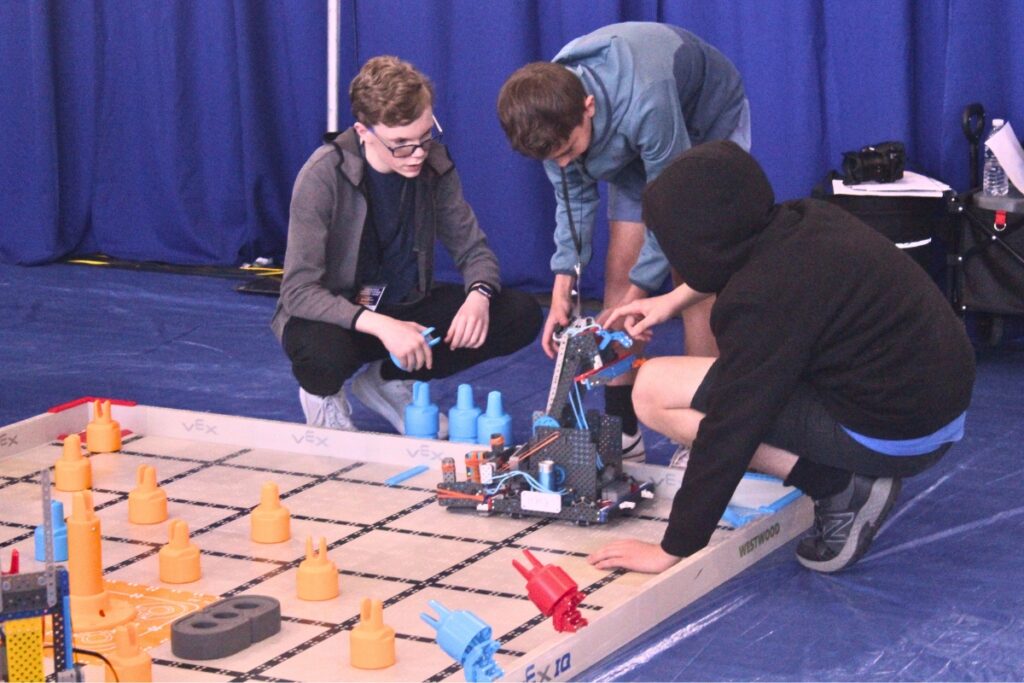 Participants look over their robot during a challenge on Thursday. Photo by Nick Anschultz
