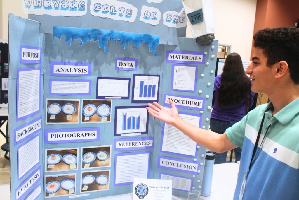 Rayan Abu-Farsakh, an eighth grader at Lote Tree Academy, shows off his science project. Photo by Nick Anschultz