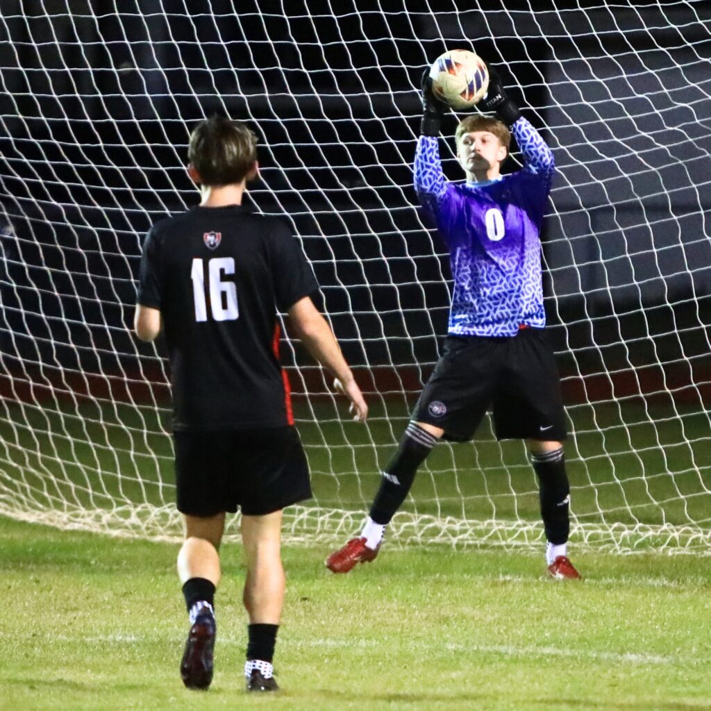Santa Fe goalkeeper Hunter LaLonde (0) with a save against Suwannee in the Class 3A-Region 1 Quarterfinals. Photo by C.J. Gish