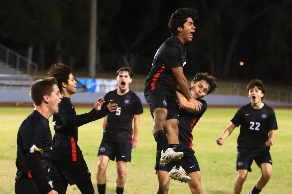Santa Fe's Dharmo Rico (jump in air) celebrates with teammates after scoring the game's first goal against Suwannee in the Class 3A-Region 1 Quarterfinals. Photo by C.J. Gish