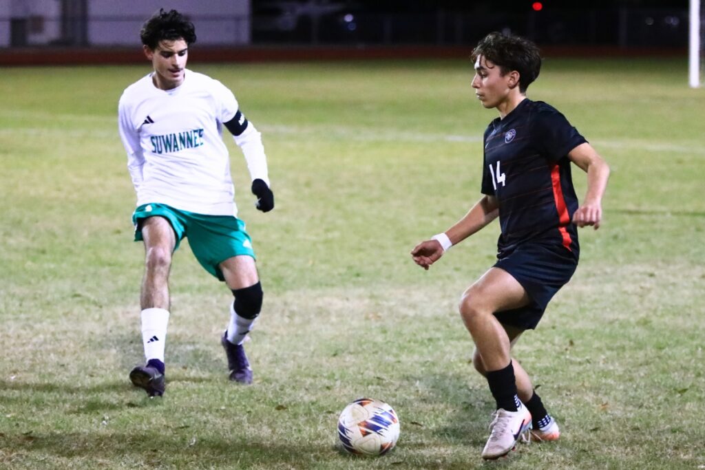 Santa Fe's Hayden Hensley (14) dribbles the ball downfield against Suwannee in the Class 3A-Region 1 Quarterfinals. Photo by C.J. Gish