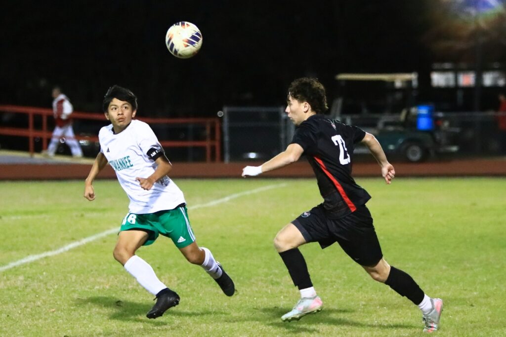 Santa Fe's Josh Cottle (23) drives the ball downfield against Suwannee's Hector Velasquez (46) in the Class 3A-Region 1 Quarterfinals. Photo by C.J. Gish