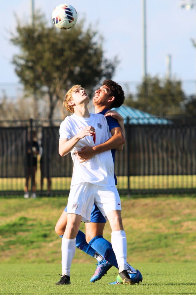 Santa Fe's Landon Thompson (7) in battle for a header against Somerset Academy-Canyons (Boynton Beach) in the Class 3A state semifinals. Photo by Vinnie Cammarano