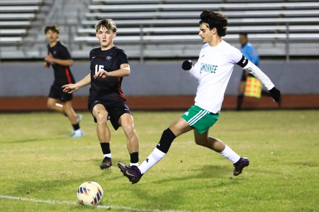 Santa Fe's Riley Fay (16) gets the ball past Suwannee's Rember Alonso (3) in the Class 3A-Region 1 Quarterfinals. Photo by C.J. Gish