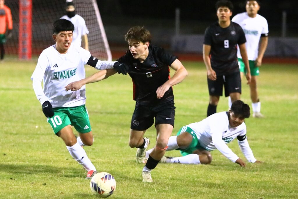 Suwannee's Phillip Yaxon (10) and Santa Fe's Owen Boone (5) battle for the ball in the Class 3A-Region 1 Quarterfinals. Photo by C.J. Gish