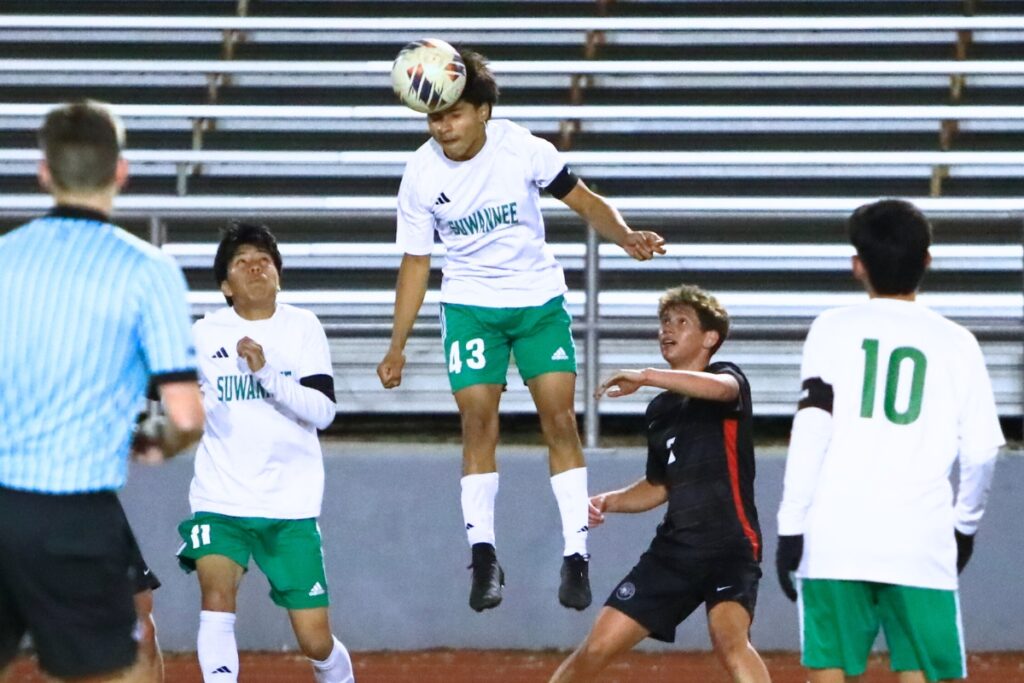 Suwannee's Sergio Castro (43) with a header against Santa Fe in the Class 3A-Region 1 Quarterfinals. Photo by C.J. Gish
