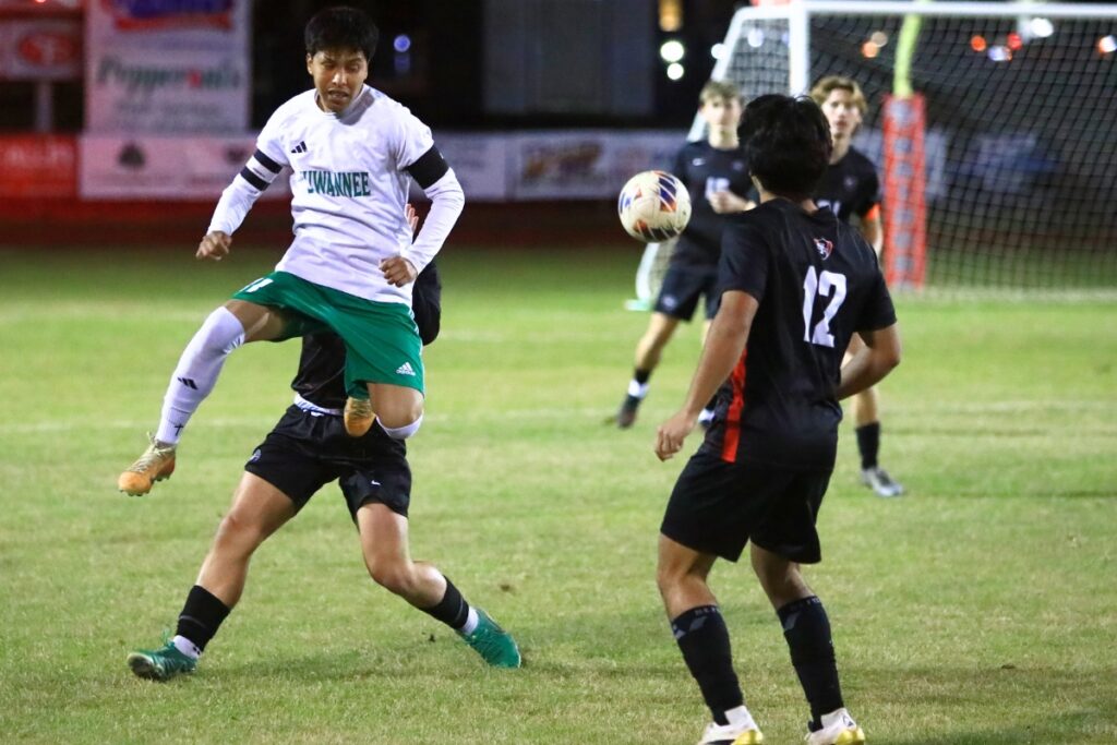 Suwanne's Scott Uribe (11) goes into the air for a ball against Santa Fe (Alachua) in the Class 3A-Region 1 Quarterfinals. Photo by C.J. Gish