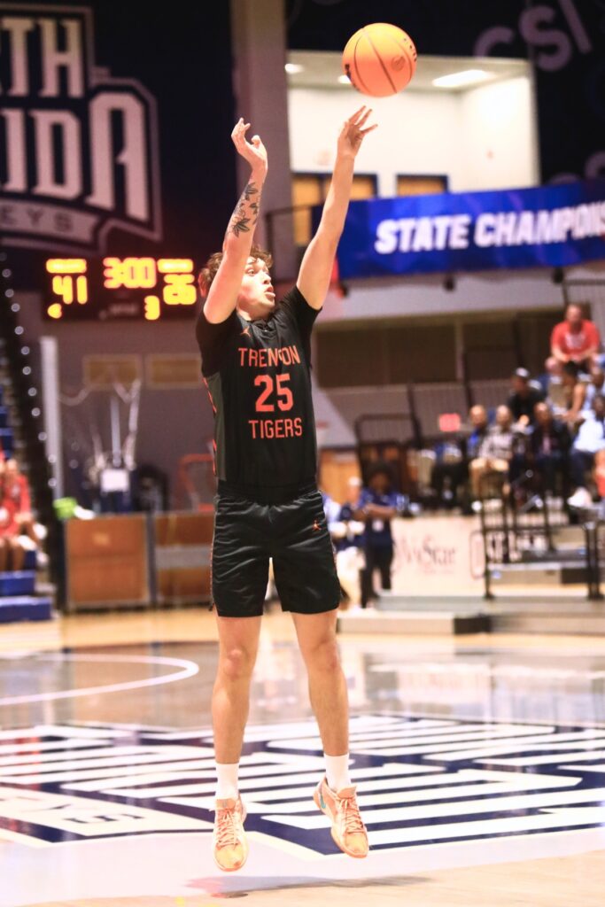 Trenton's Hunter Hilliard (25) launches a 3-point shot against Williston in the Rural state semifinals. Photo by C.J. Gish