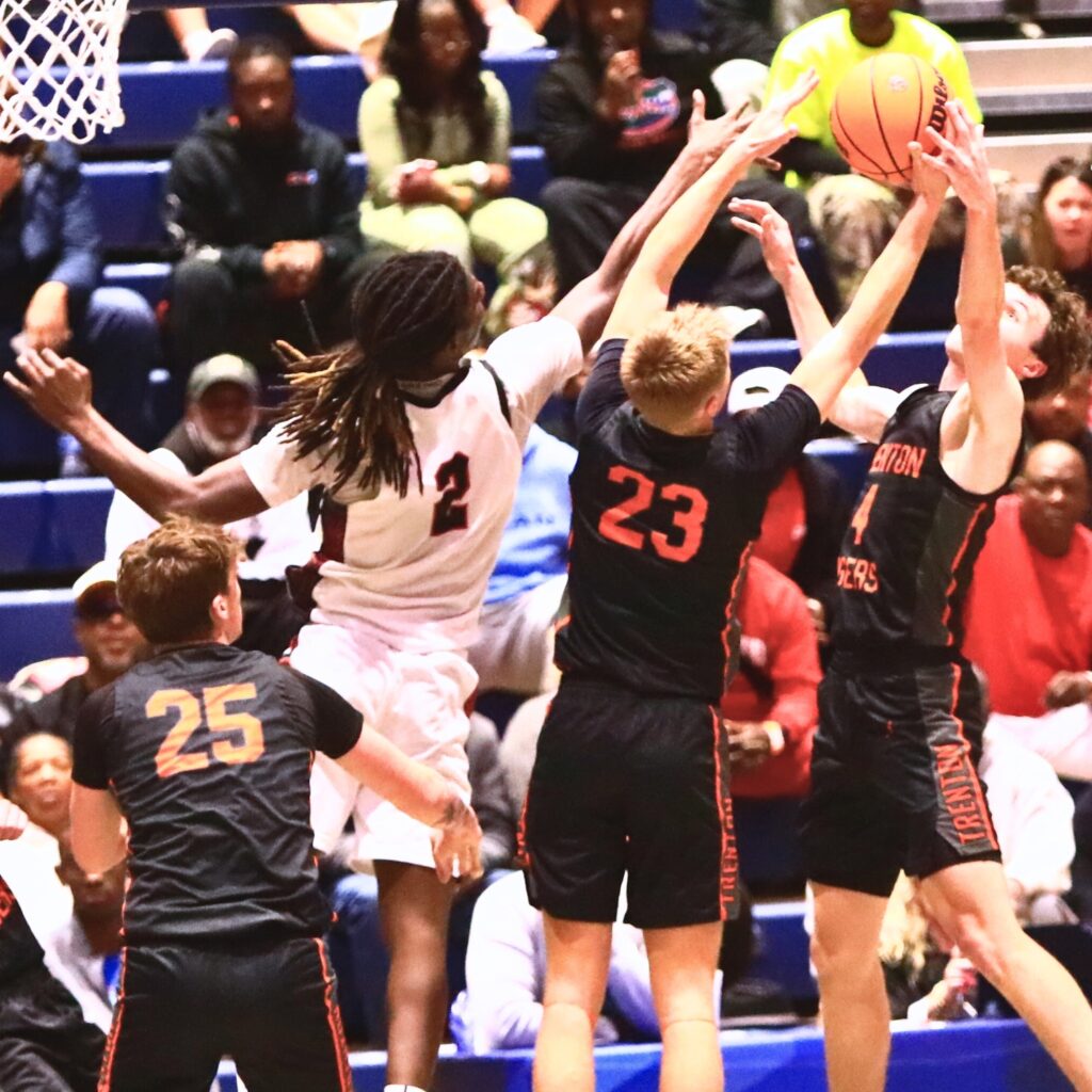 Trenton's Noah Owens (4) and Marc Micale (23) battle Williston's Jaden Magee (2) for a rebound in the Rural state semifinals. Photo by C.J. Gish