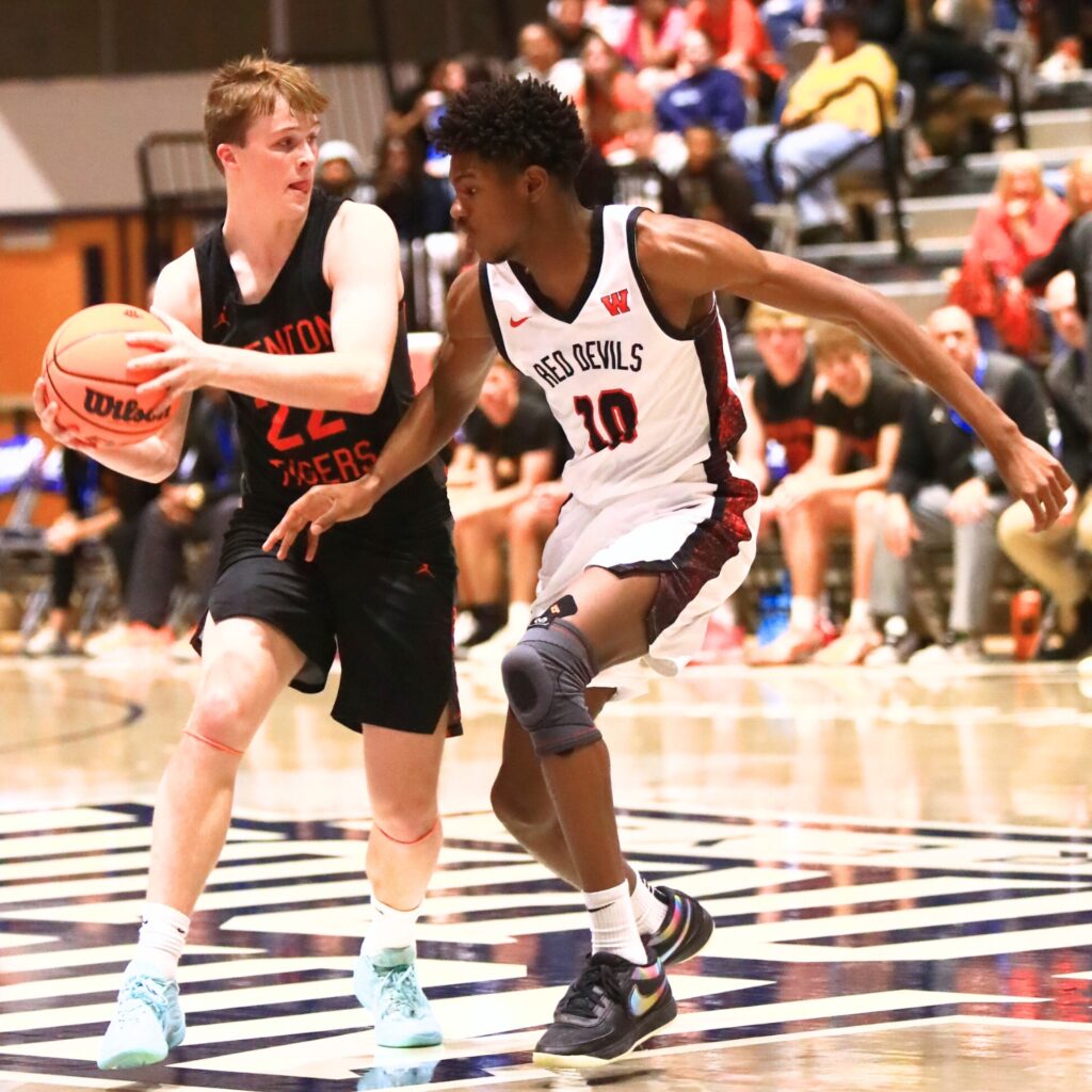Trenton's Tyler Bullis (22) looks to pass against Williston's Malachi Fernandez (10). Photo by C.J. Gish