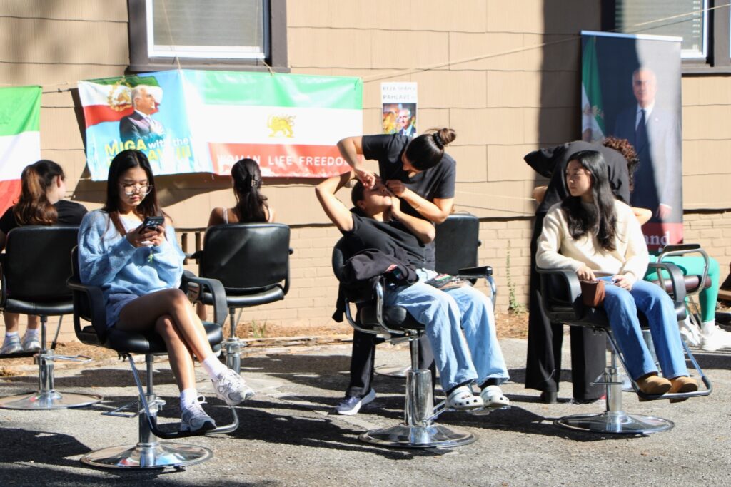 UF students wait on Ahmadi and Hosseini to thread their eyebrows during the world record attempt. Photo by Lillian Hamman