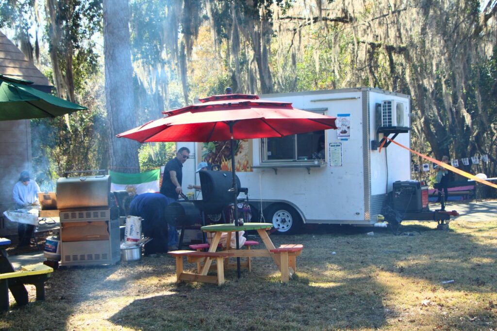 Volunteers cook up Persian food at Ziba Ahmadi's Galan Kebab food truck on site of her world record attempt. Photo by Lillian Hamman