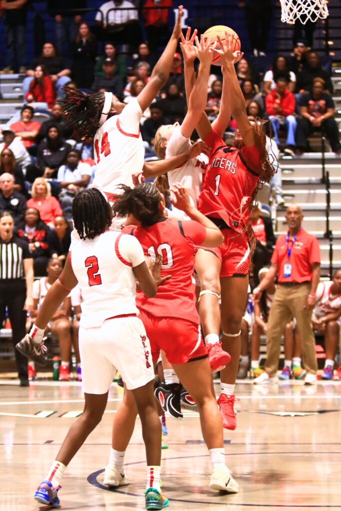 Williston and Blountstown players battle for a rebound in the Rural state semifinals. Photo by C.J. Gish