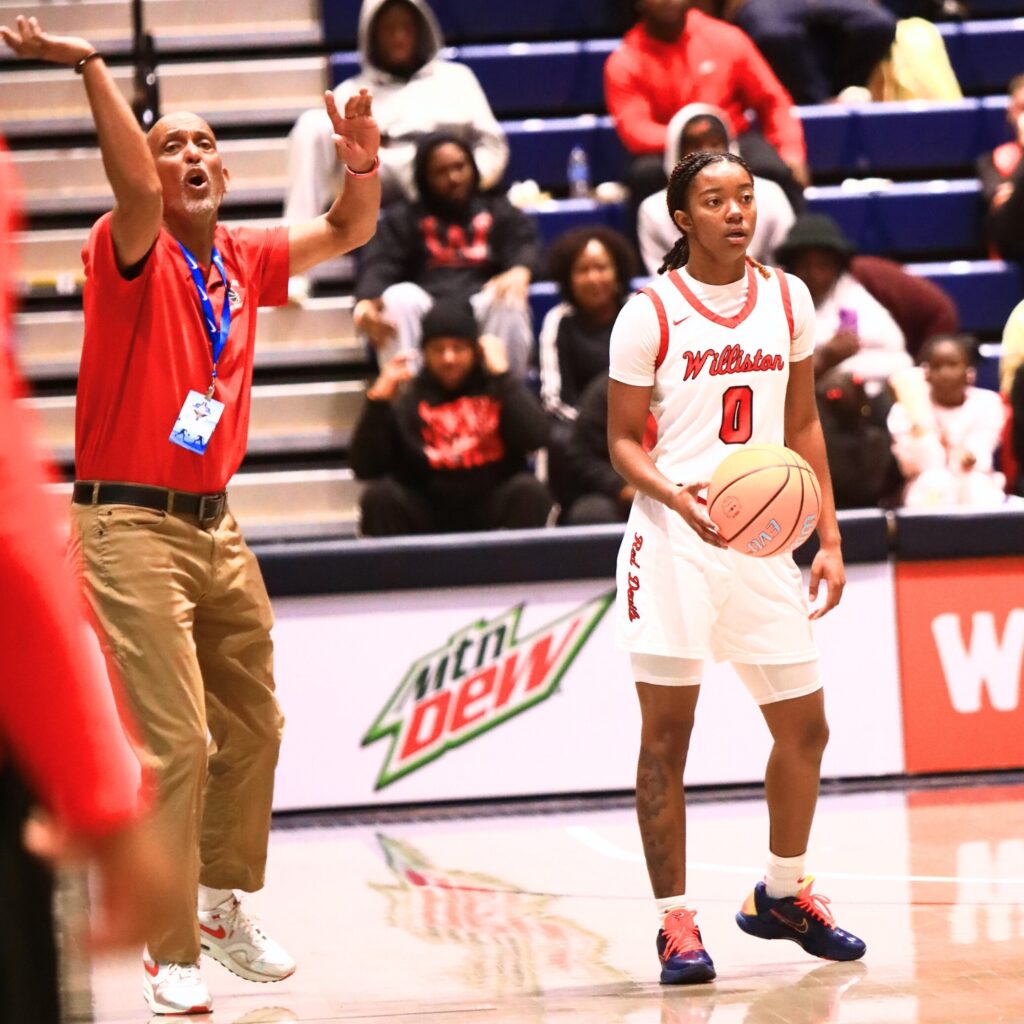 Williston coach Willie Powers yells out instructions as Ashlyn Young (0) brings the ball down the court against Blountstown in the Rural state semifinals. Photo by C.J. Gish