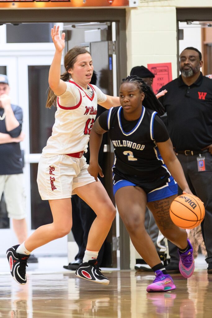 Williston's Baylee Cribbs (12) defends the basket against Wildwood in the Rural-Region 4 Final. Photo by Megan V. Winslow