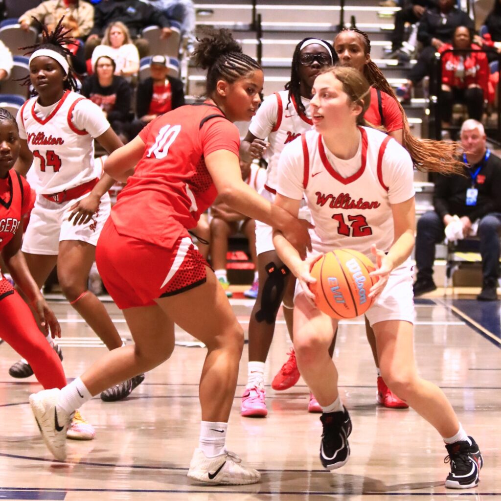 Williston's Baylee Cribbs (12) looks to pass following a rebound against Blountstown in the Rural state semifinals. Photo by C.J. Gish