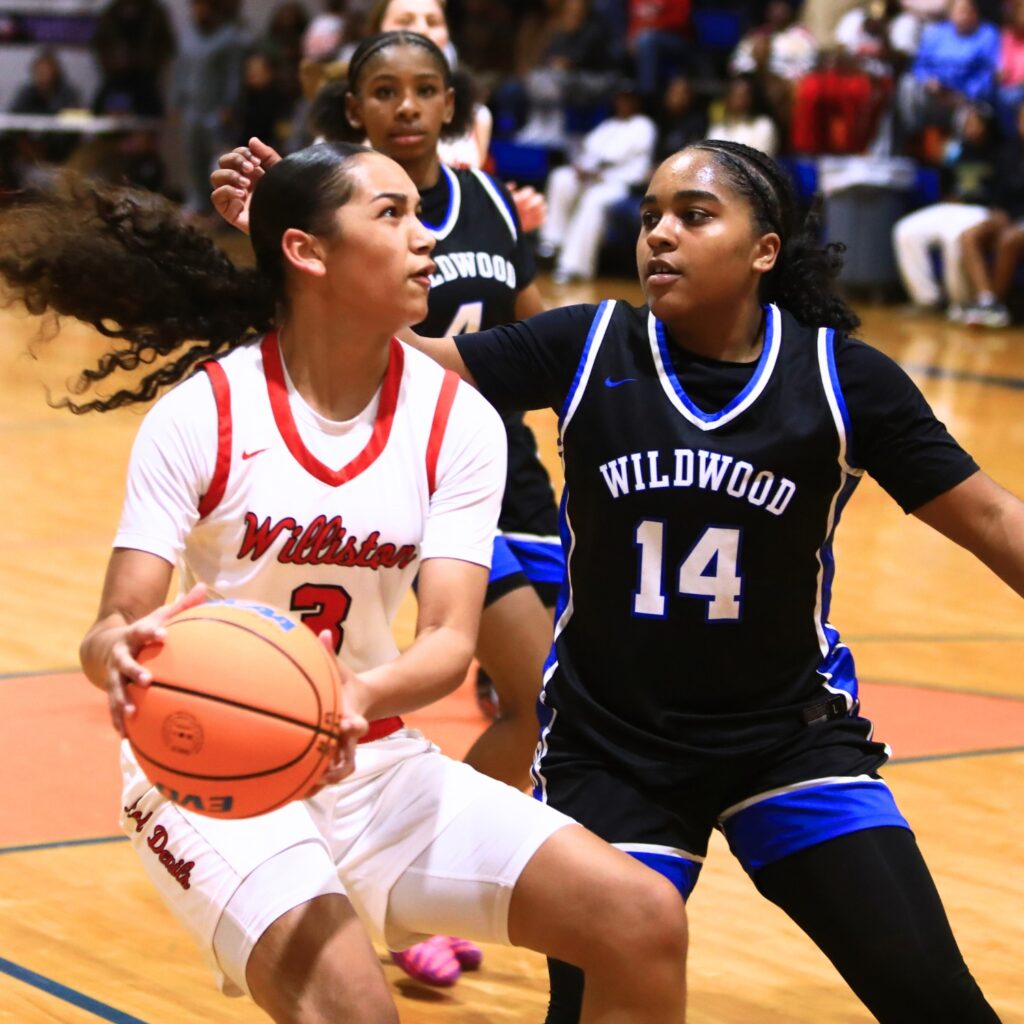 Williston's Delecia Dallas (3) drives to the basket against Wildwood in the Rural Class District 7 championship game. Photo by C.J. Gish
