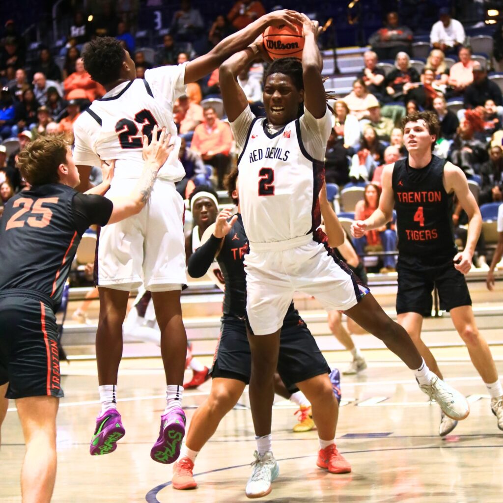 Williston's Jaden Magee (2) with a rebound against Trenton in the Rural state semifinals. Photo by C.J. Gish