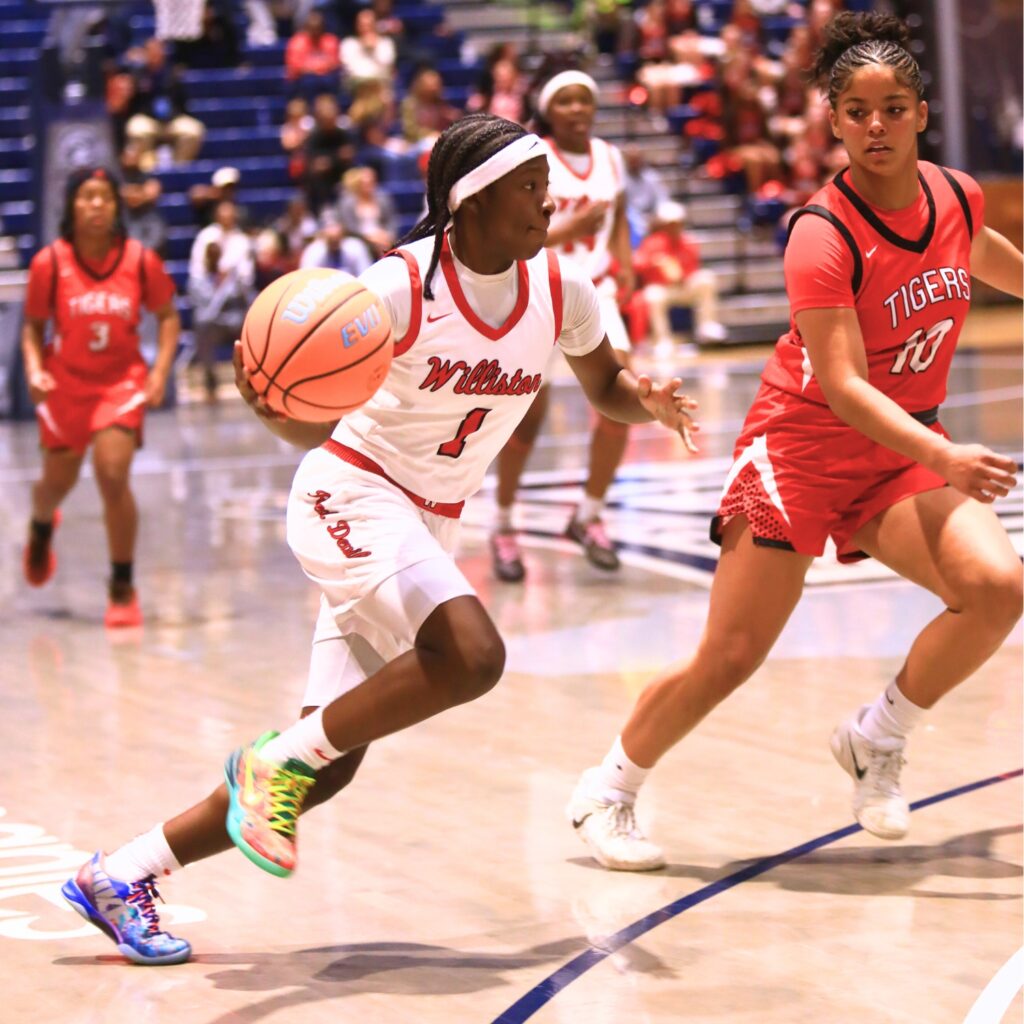Williston's Kierce Solomon (1) drives to the basket against Blountstown in the Rural state semifinals. Photo by C.J. Gish