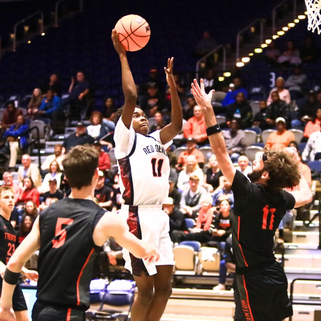 Williston's Kyson Chever (11) puts up a shot against Trenton's Nathan Ridgell (11) in the Rural state semifinals. Photo by C.J. Gish