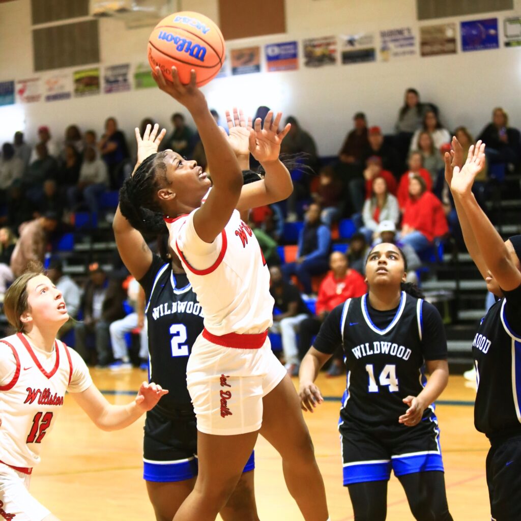 Williston's Tiona Wilkinson (4) puts up a shot against Wildwood in the Rural Class District 7 championship game. Photo by C.J. Gish