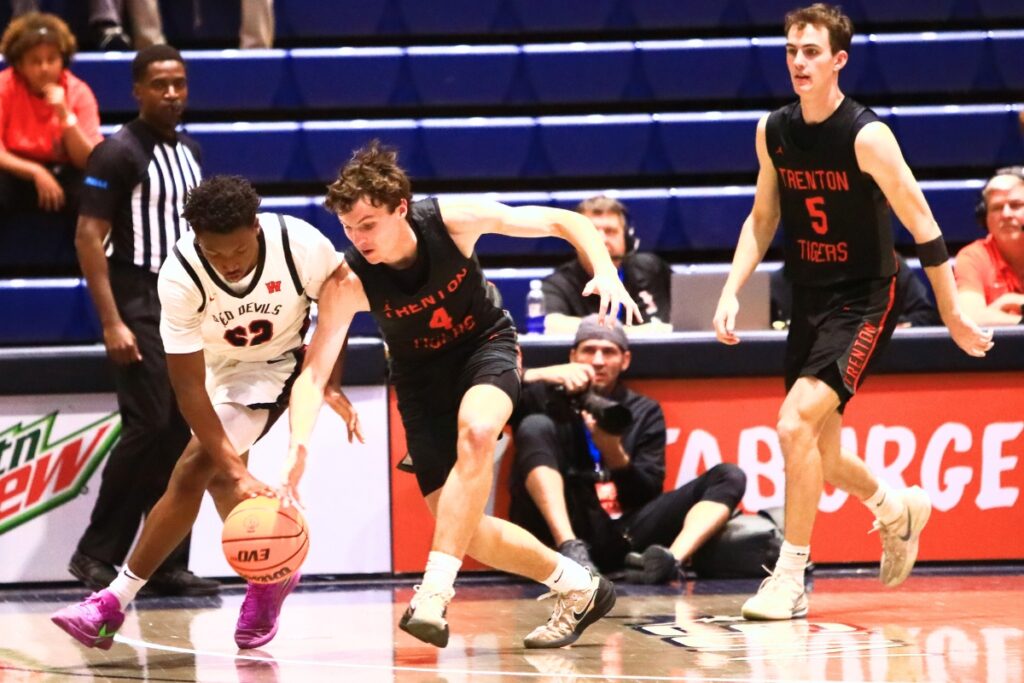 Williston's Traeston Armstrong (22) and Trenton's Noah Owens (4) battle for a loose ball in the Rural state semifinals. Photo by C.J. Gish