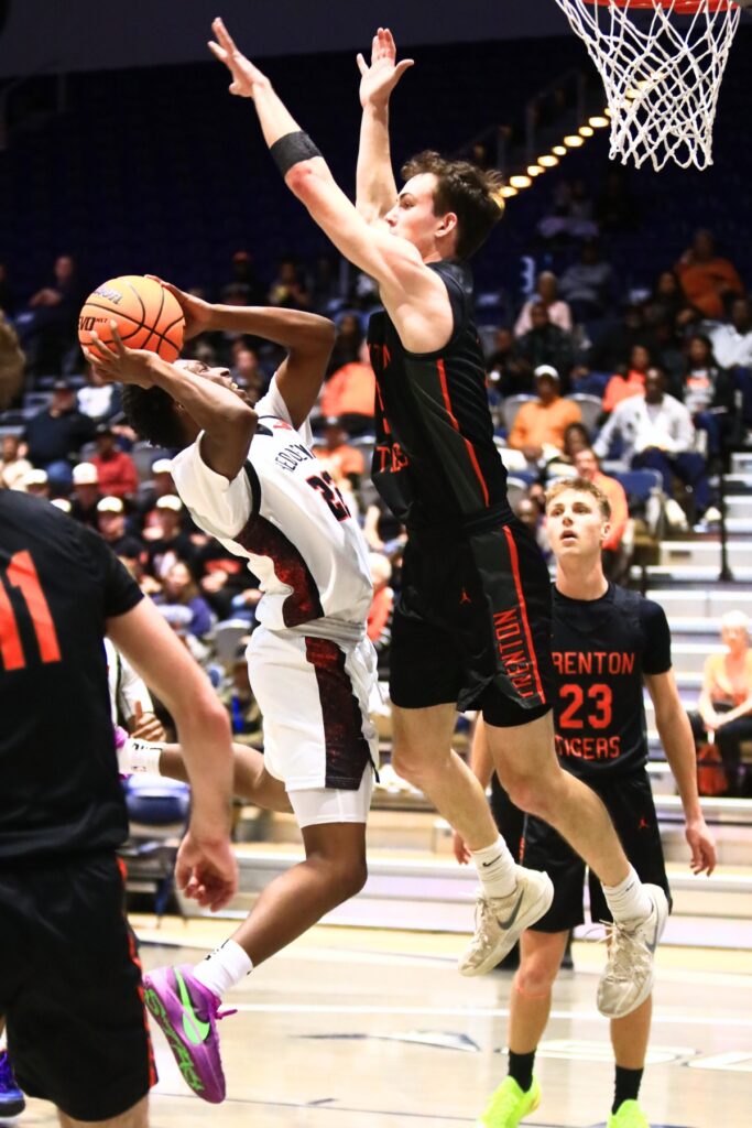 Williston's Traeston Armstrong (22) puts up a shot against Trenton's Mason Vuncannon (5) in the Rural state semifinals. Photo by C.J. Gish