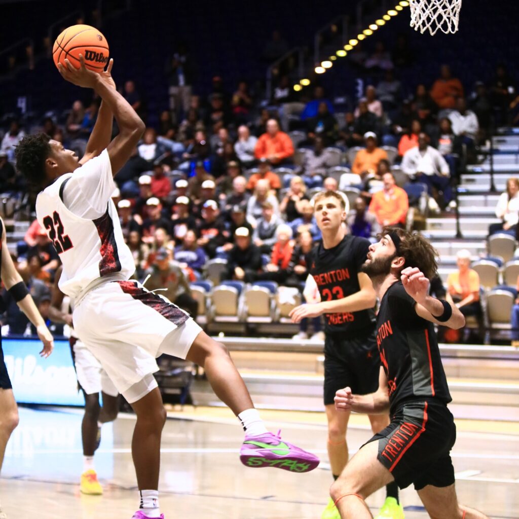 Williston's Traeston Armstrong (22) puts up a shot against Trenton's Nathan Ridgell (11) in the Rural state semifinals. Photo by C.J. Gish