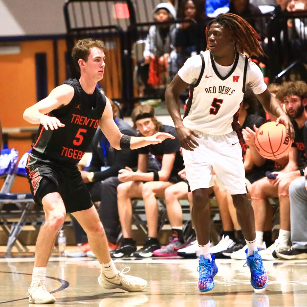 Williston's Treston Jones (5) dribbles against Trenton's Mason VunCannon (5) in the Rural state semifinals. Photo by C.J. Gish