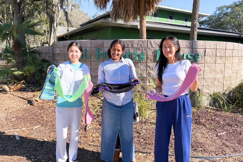 (From left) Winny Wang, Kia Herron-Sabi Goura and Rachel Dai pose for a photo with the donated scarfs. Courtesy of Kia Herron-Sabi Goura