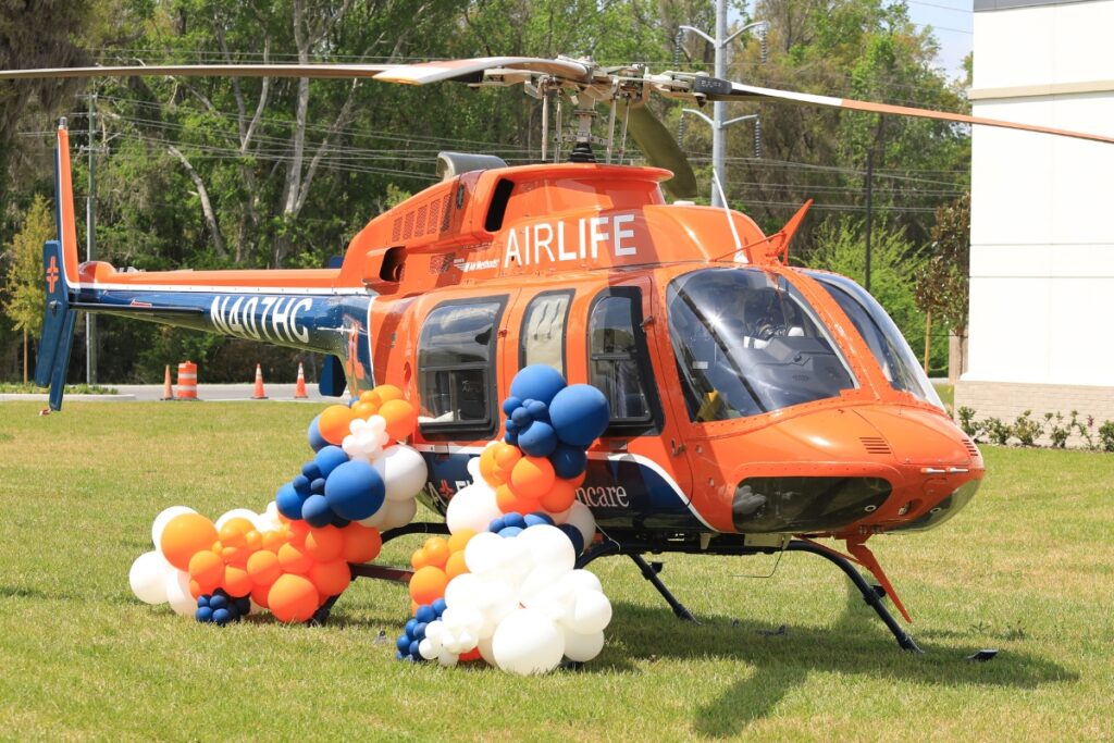Air Methods will transport patients on a Bell 407GX, pictured on a grass field behind the hospital.