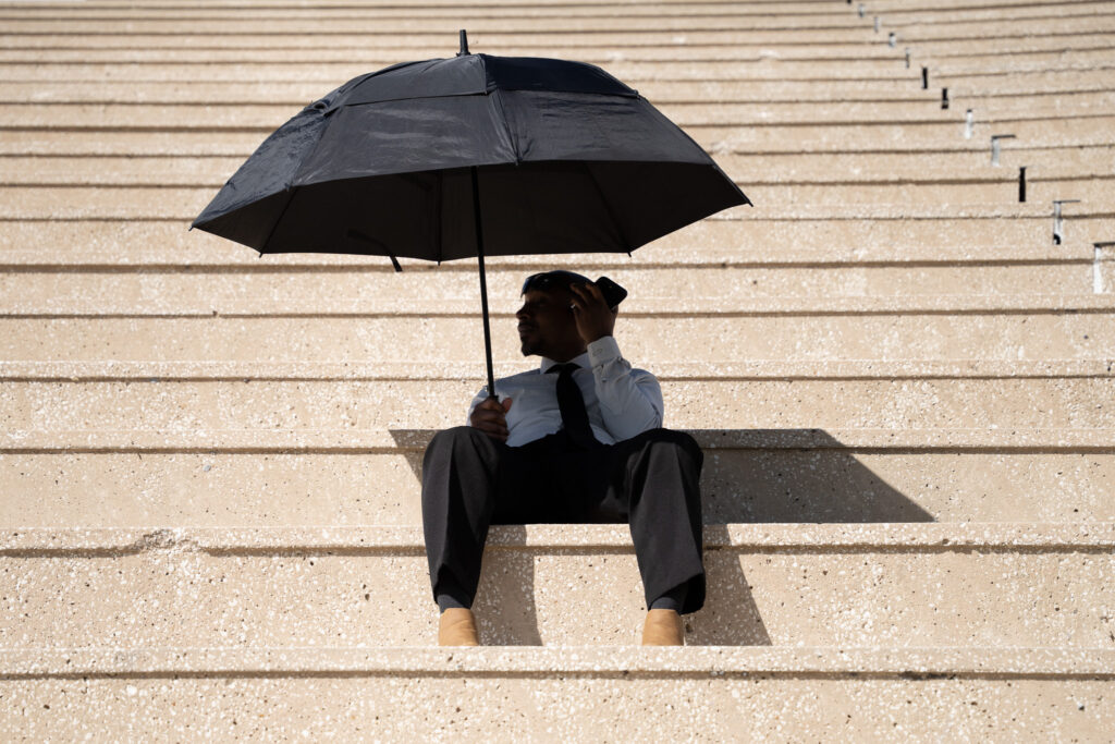 Barry Allen sits in the spectator stands as he waits for the Fifth Grade Field Day to start.