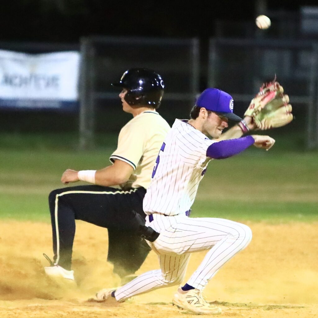 Buchholz's Drew Almond (8) slides safely into second base against Gainesville's Ty Quinn (5). Photo by C.J. Gish