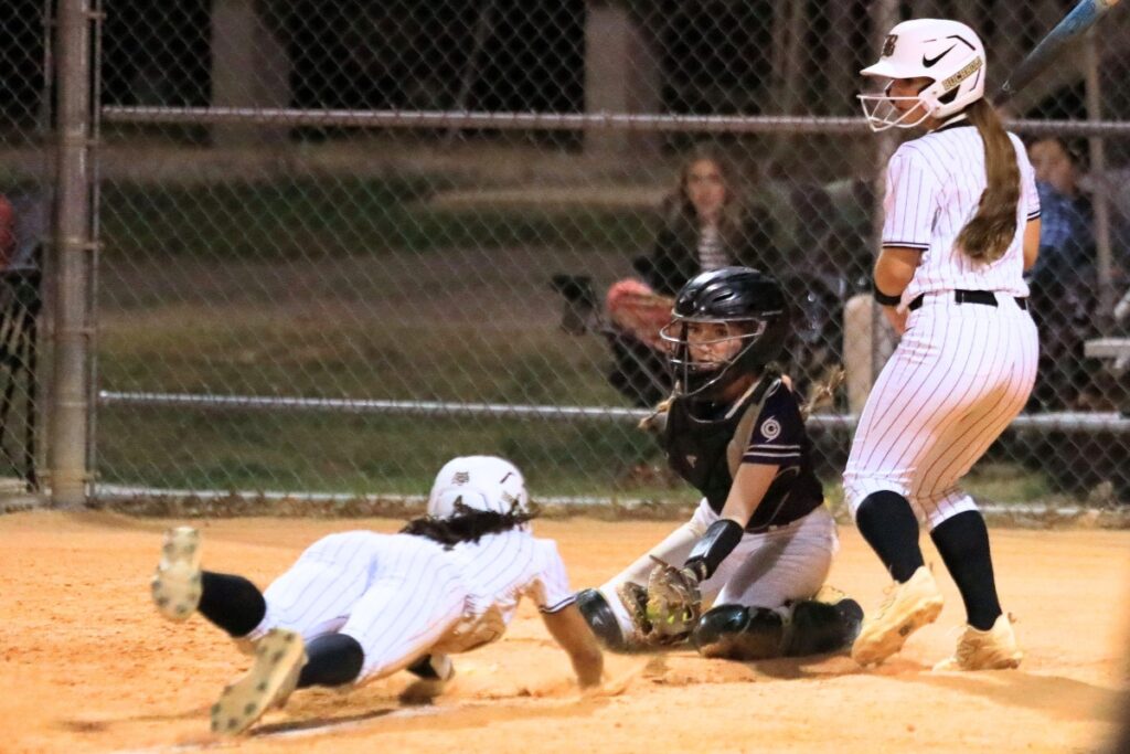 Buchholz's Jordyn Cooper tries to steal home but gets called out to end the inning against Gainesville. Photo by Seth Johnson