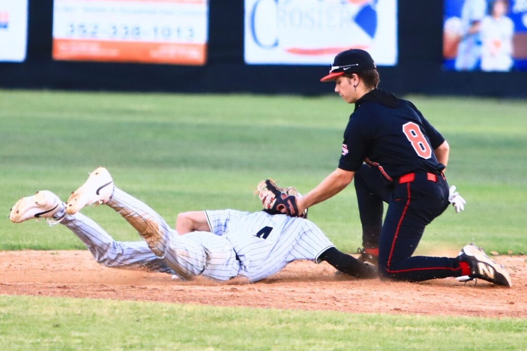 Buchholz's Zac Brown (4) dives back safely under the tag of Santa Fe's Dylan Doria (8) in the third inning. Photo by C.J. Gish