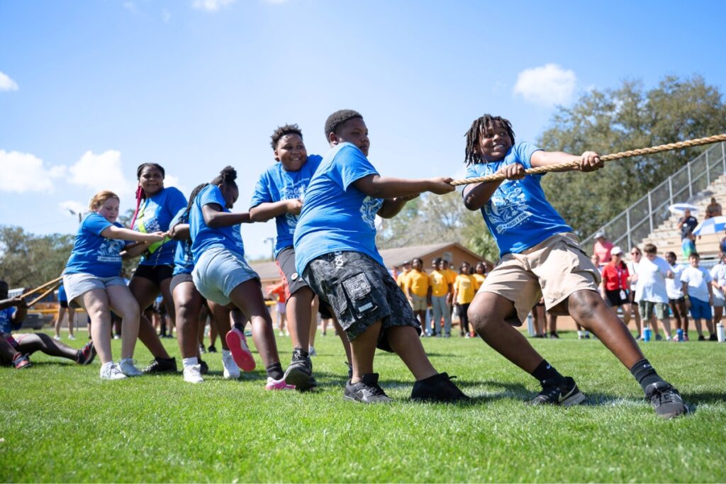 Devon Mackey leading his classmates to victory in the tug-of-war at Citizens Field. Photo by Tim Rodriquez