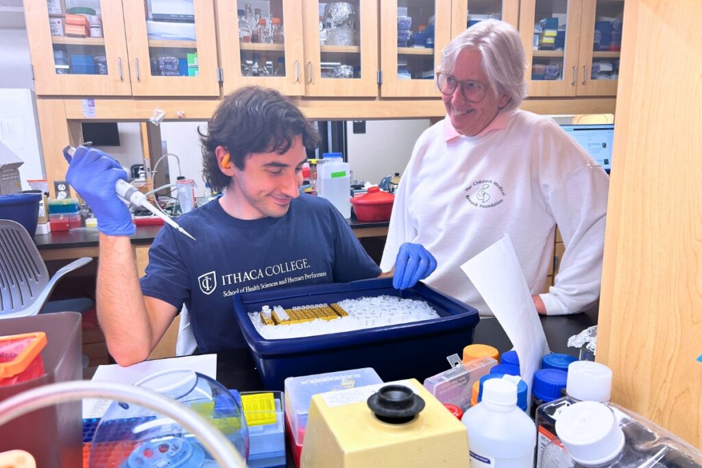 Dr.  Karyn Esser looks on as doctoral student Spencer Procopio conducts his research in the lab. Photo by Ronnie Lovler
