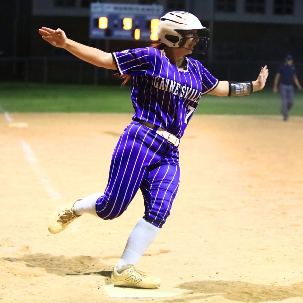 Gainesville's Aubree Suarez (7) scores the winning run in the bottom of the ninth inning against Trenton. Photo by C.J. Gish