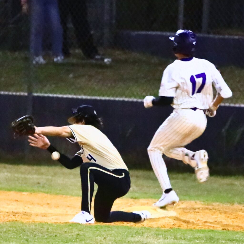 Gainesville's Esteban Barranco (17) gets to first base safely against Buchholz's Zac Brown (4) in the bottom of the second inning. Photo by C.J. Gish